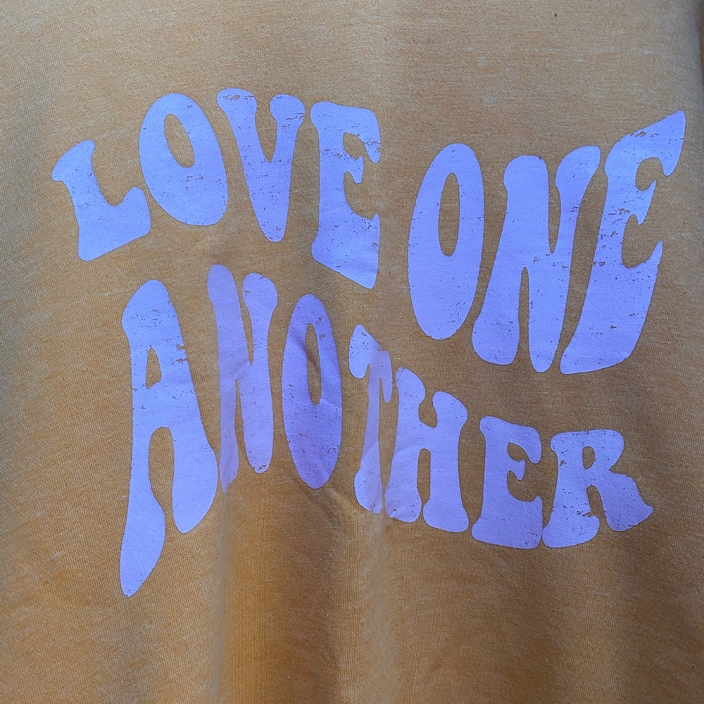Love one another sweatshirt.  Orange with lavender writing.  Worn a few times.